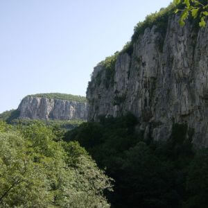 Photo of cliffs surrounding Bacho Kiro Cave, one of the first sites in Europe to be occupied by modern humans
